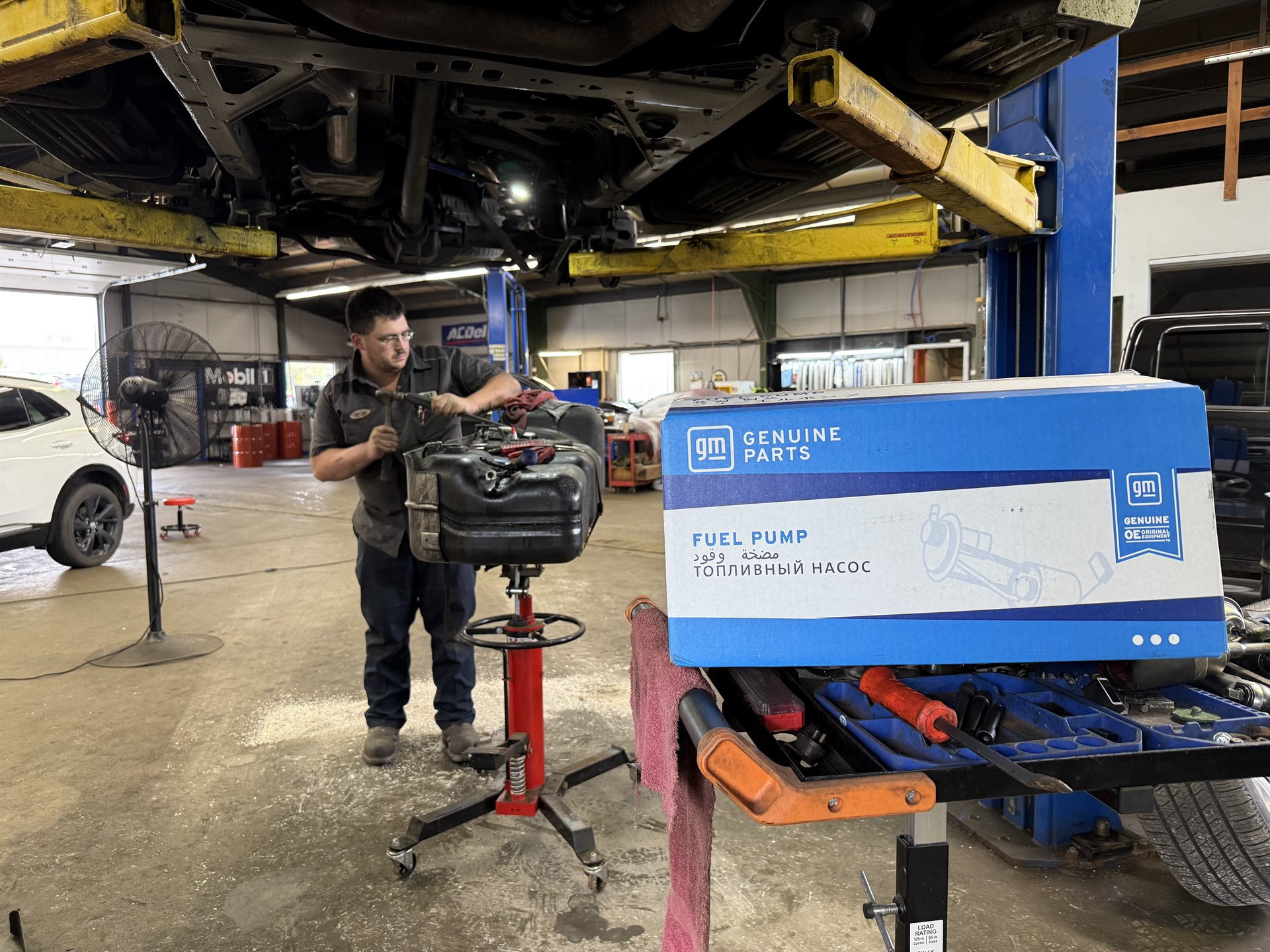 Mechanic performing a fuel pump replacement on a GMC Envoy using GM Genuine Parts at Seidle''''''''''''''''s of Clarion in Clarion, PA.