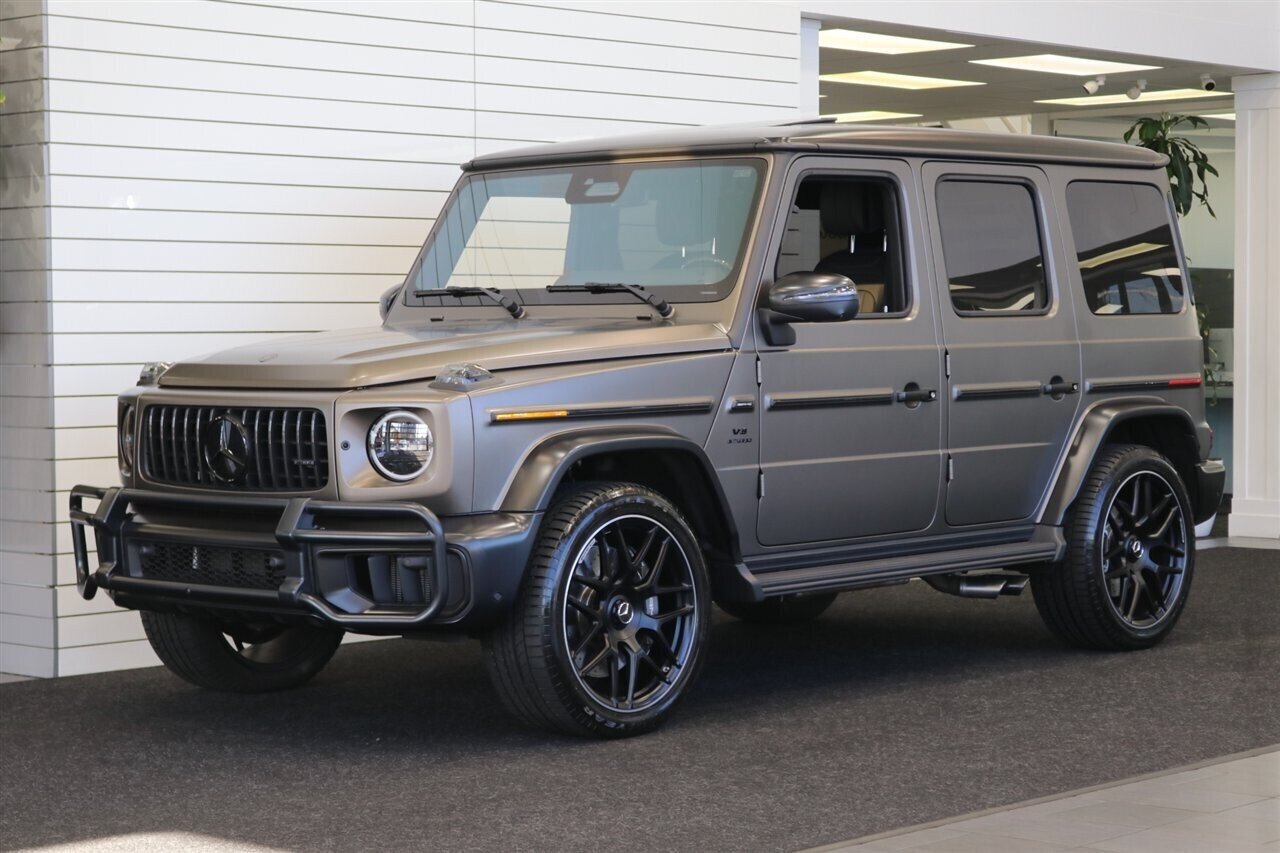 2025 Mercedes-Benz AMG G 63  1-OWNER* FULL PPF ON FRONT NOSE* MONZA GREY MAGNO-CARBON FIBER INTERIOR TRIM-22 " AMG WHEELS-EXCLUSIVE INTERIOR PLUS-AMG NIGHT PACKAGE MAGNOAMG PERFORMANCE STEERING WHEEL-BLACK MAGNO ROOF* - Photo 1 - Portland, OR 97230